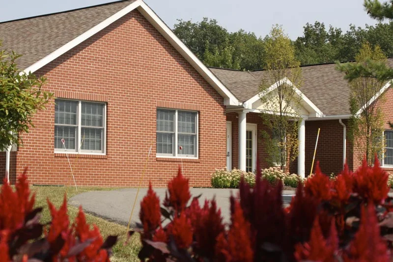 The front of the Marywood Domiano Center with red plants in front